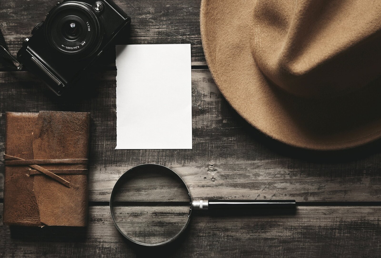 private-investigator-closed-notebook-leather-cover-sheet-white-paper-felt-brown-hat-camera-big...jpg